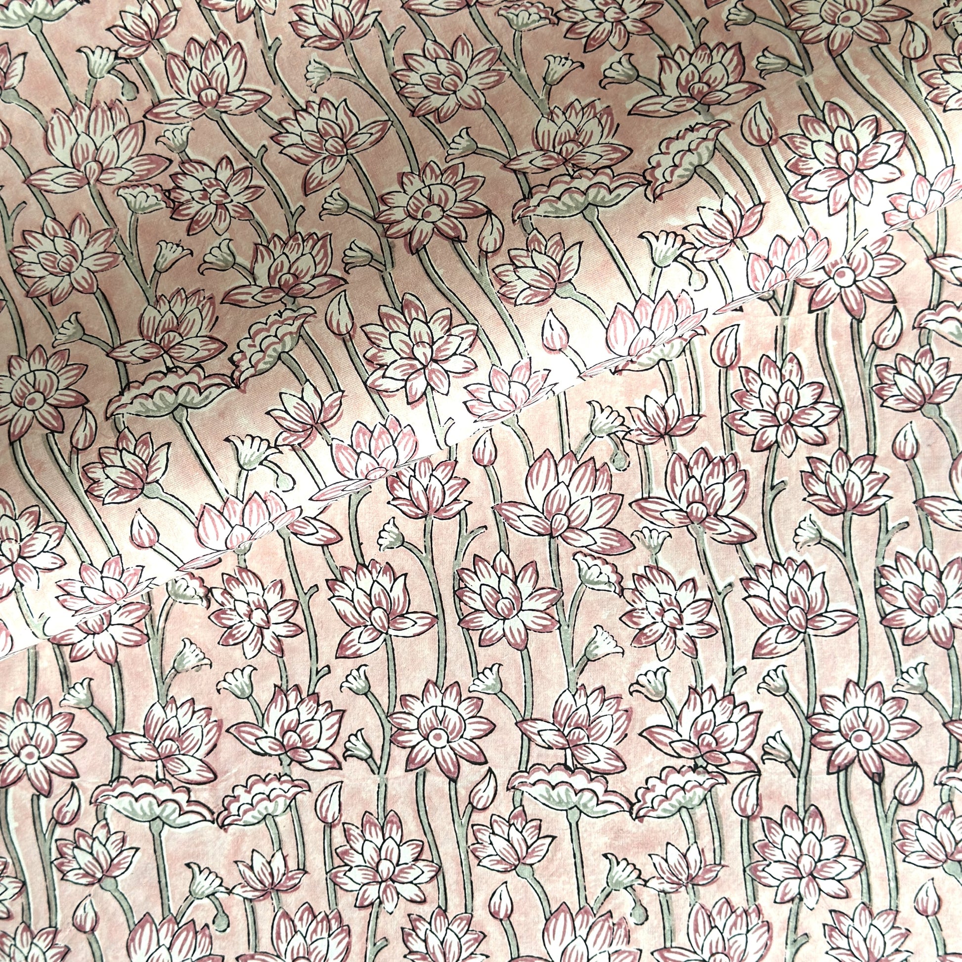 hand block printed wrapping paper by Paper Mirchi. Lotus flower repeat pattern in pale pink