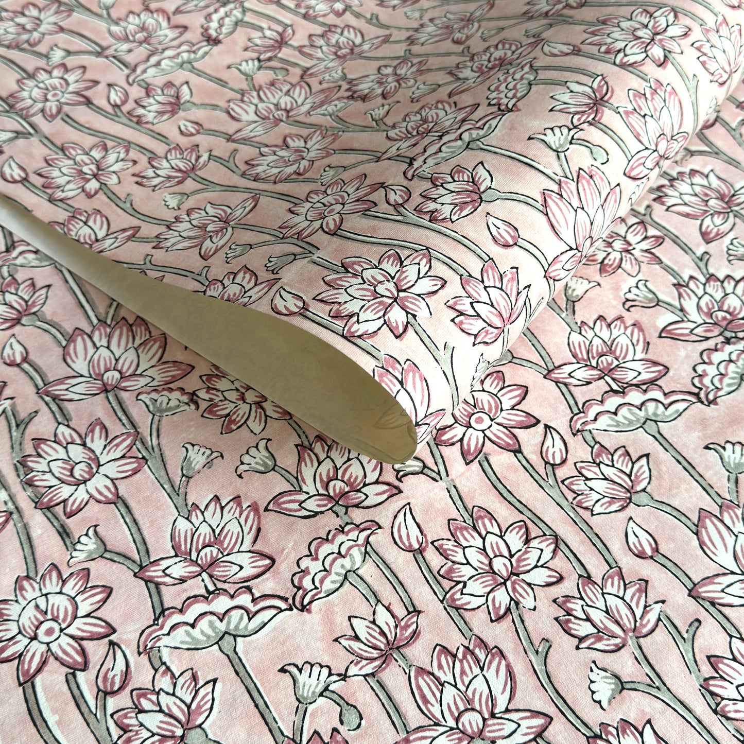 hand block printed wrapping paper by Paper Mirchi. Lotus flower repeat pattern in pale pink