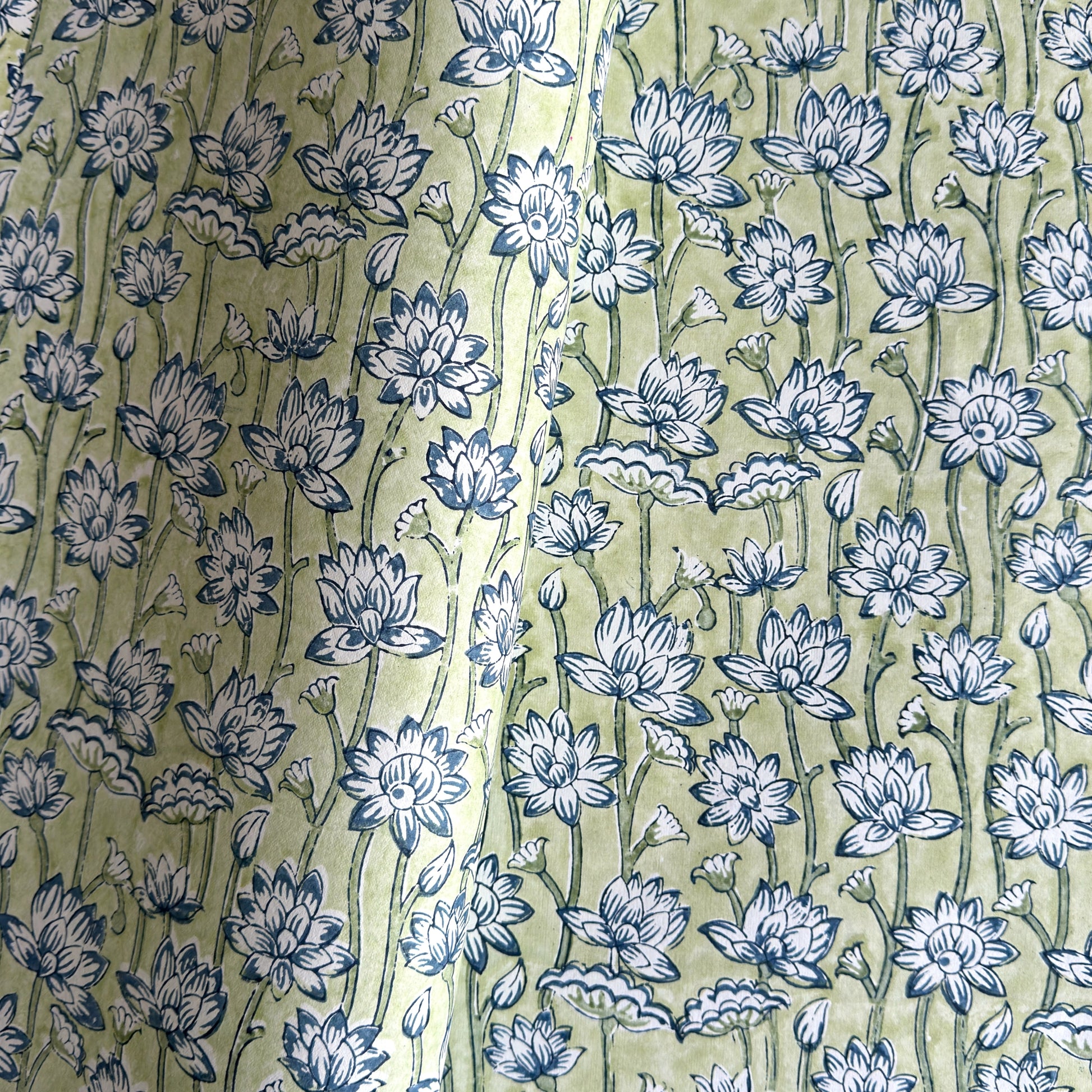 hand block printed wrapping paper with a repeat lotus flower design in indigo and light green. By Paper Mirchi