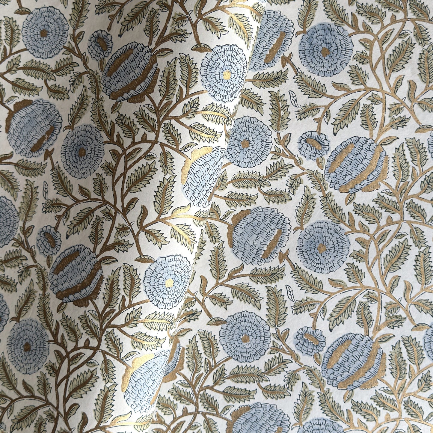 wrapping paper with repeat botanical pattern in blue, gold and green by Paper Mirchi