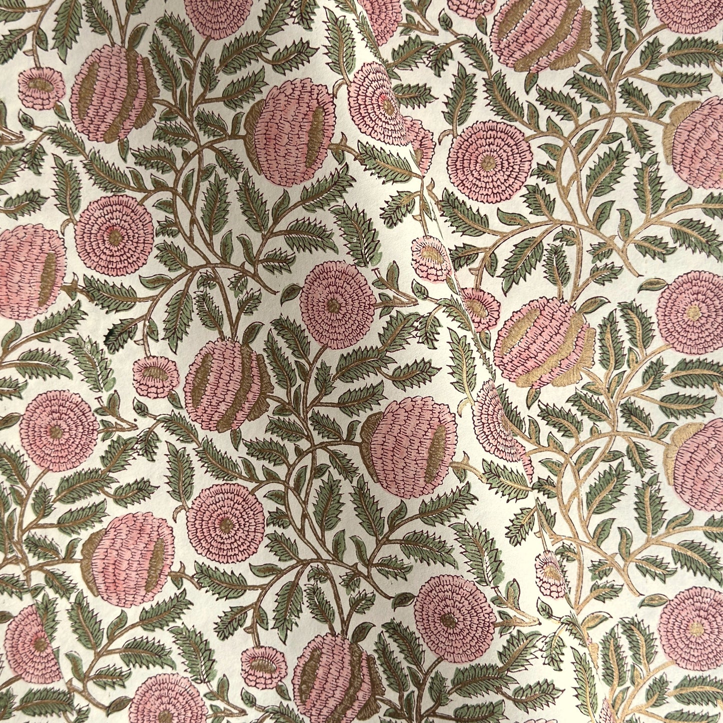 wrapping paper with repeat botanical pattern in pink, gold and green by Paper Mirchi