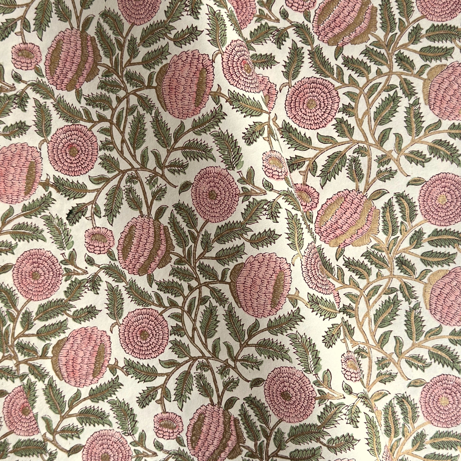 wrapping paper with repeat botanical pattern in pink, gold and green by Paper Mirchi