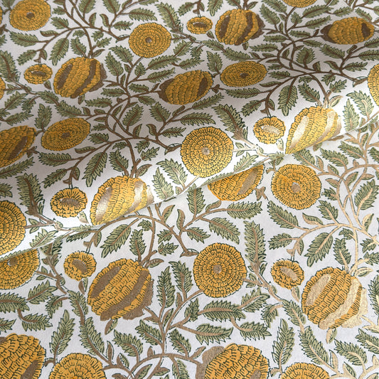 wrapping paper with repeat botanical pattern in yellow, gold and green by Paper Mirchi