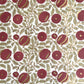 hand block printed paper by Paper Mirchi.  A floral repeat pattern in deep burgundy, pale green and gold.
