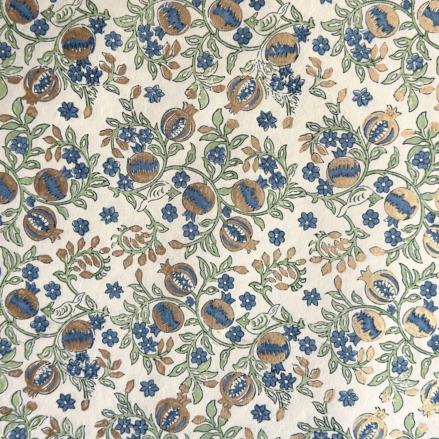 hand block printed wrapping paper with a pomegranate design in indigo and green with gold accent. By Paper Mirchi