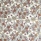hand block printed wrapping paper by Paper Mirchi.  Repeat pattern of pomegranates in pink and green within a gold accent design.