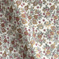 hand block printed wrapping paper by Paper Mirchi.  Repeat pattern of pomegranates in pink and green within a gold accent design.
