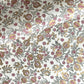 hand block printed wrapping paper by Paper Mirchi.  Repeat pattern of pomegranates in pink and green within a gold accent design.