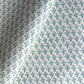 wrapping paper with repeat block print little floral pattern in aqua by Paper Mirchi