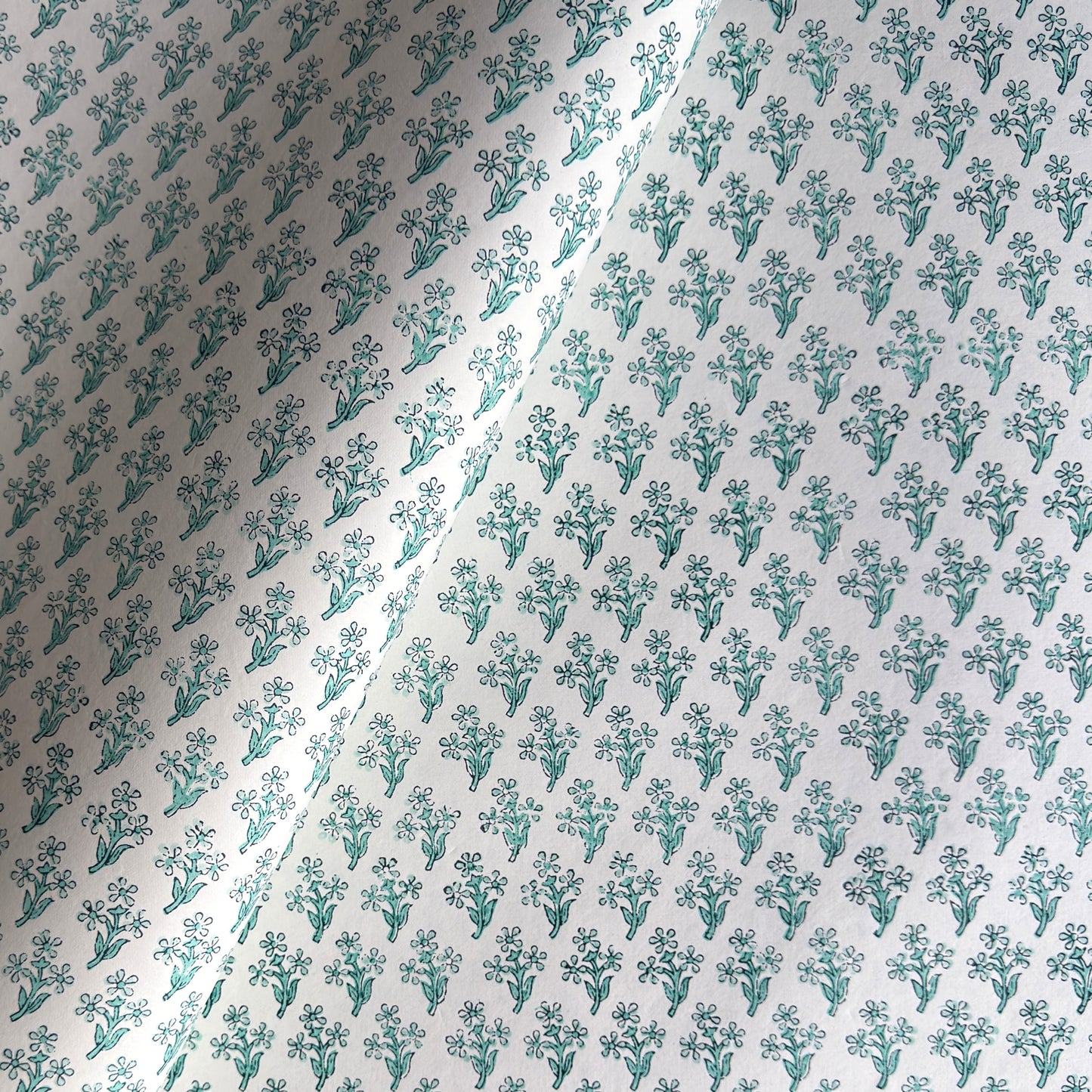 wrapping paper with repeat block print little floral pattern in aqua by Paper Mirchi