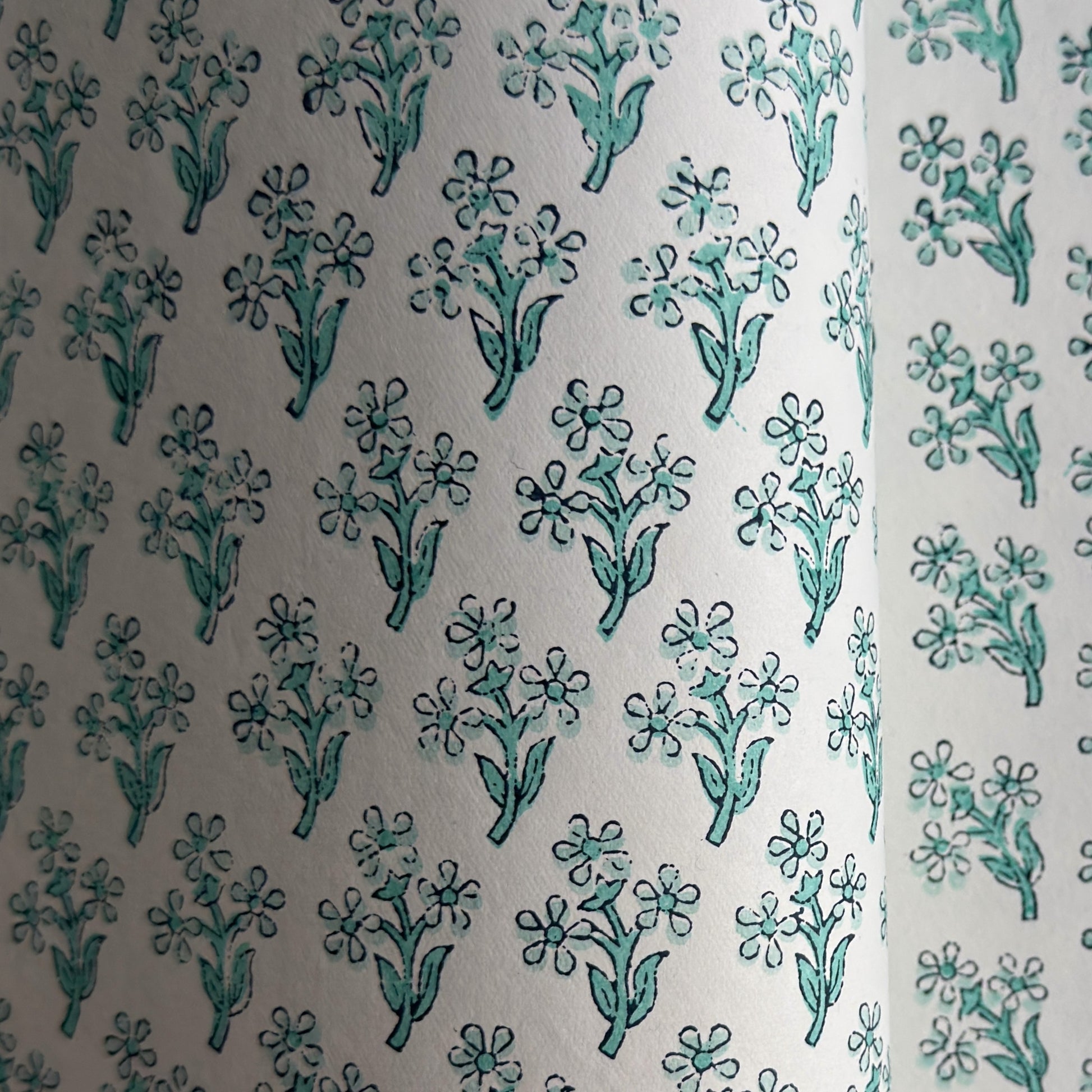 wrapping paper with repeat block print little floral pattern in aqua by Paper Mirchi