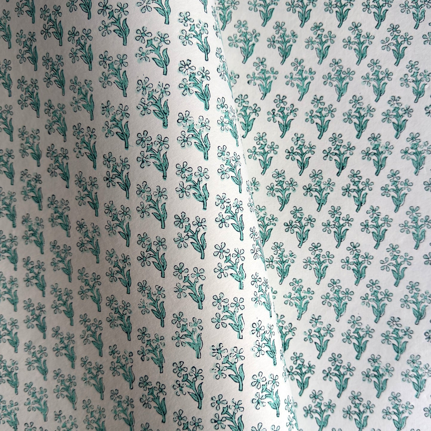 wrapping paper with repeat block print little floral pattern in aqua by Paper Mirchi