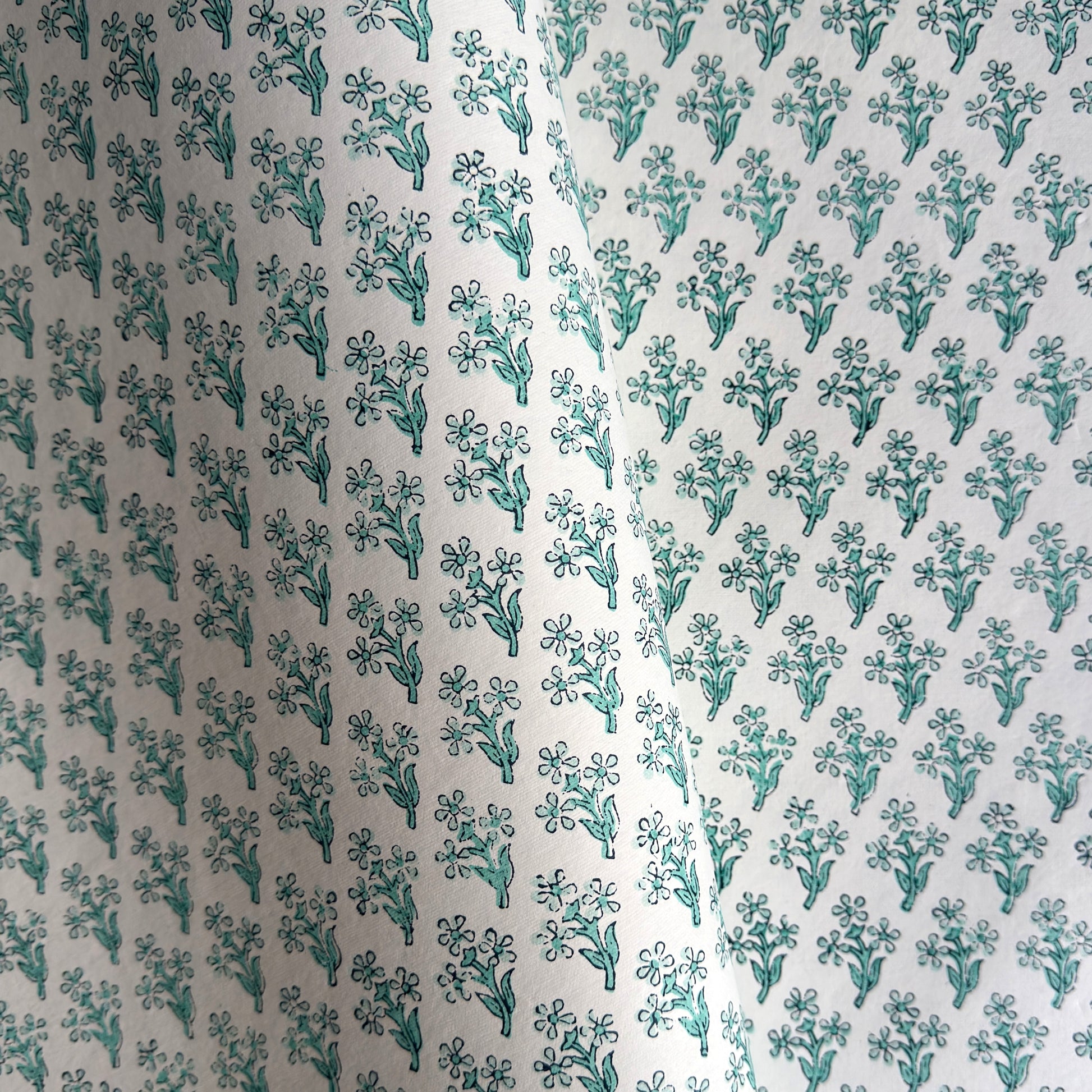 wrapping paper with repeat block print little floral pattern in aqua by Paper Mirchi