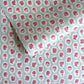 a sheet of hand block printed wrapping paper with a ditsy floral pattern of pink flowers in white ovals with a soft blue backdrop