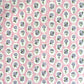 a sheet of hand block printed paper with a ditsy floral design, little violet flowers in a white oval with a pink background