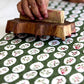 close up of a sheet of paper being hand block printed