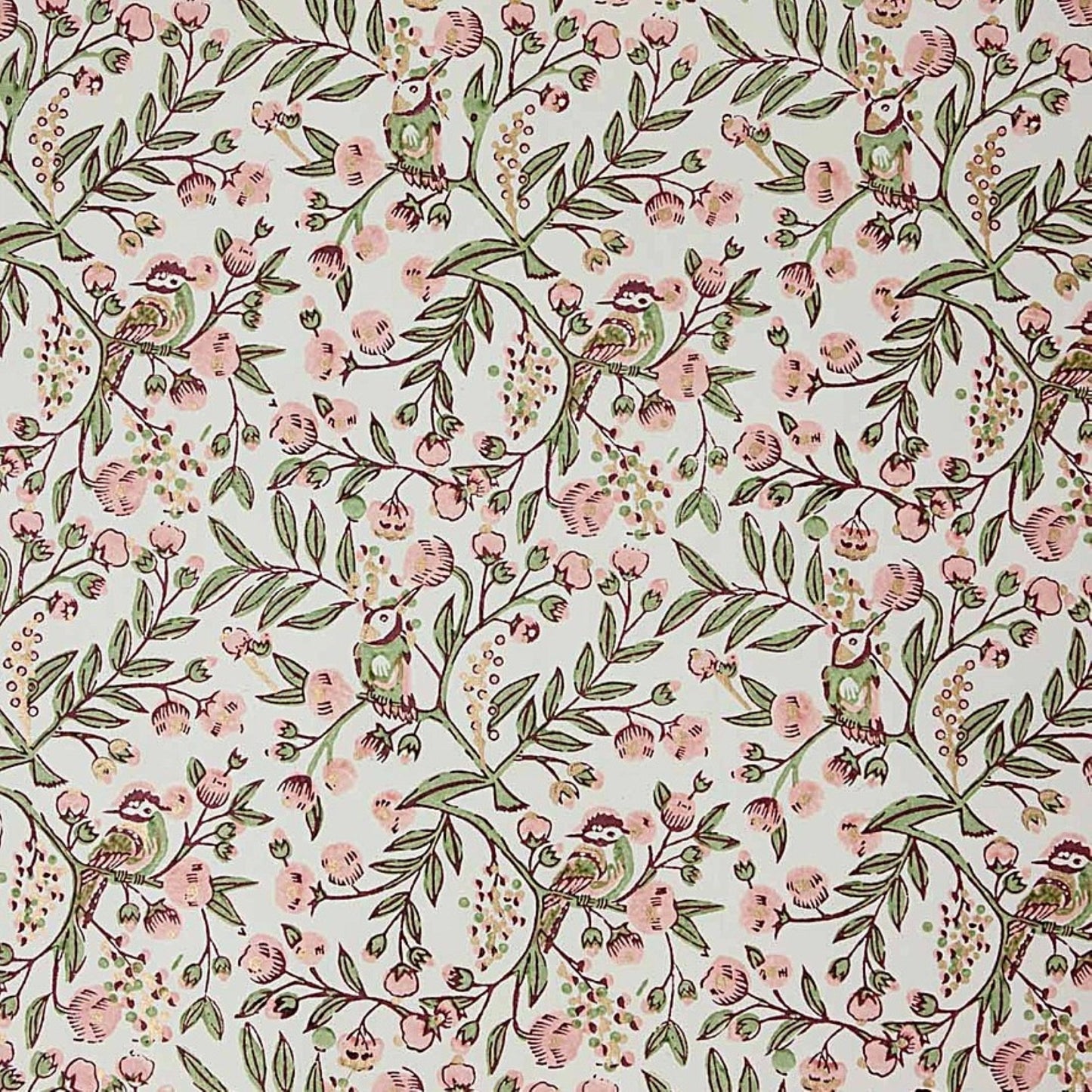 a sheet of hand-block printed wrapping paper with a pattern of a songbird amongst flowering branches in blush pink, soft green and gold