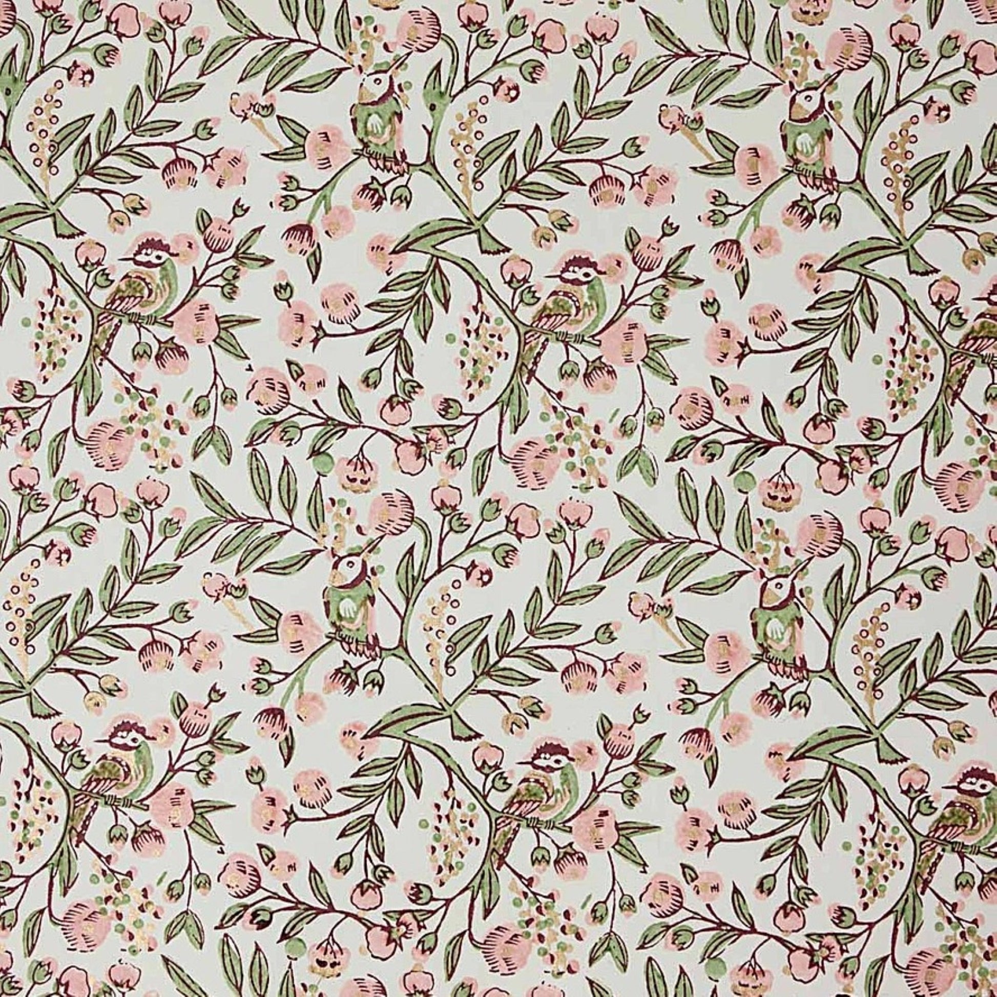 a sheet of hand-block printed wrapping paper with a pattern of a songbird amongst flowering branches in blush pink, soft green and gold