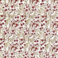 a sheet of hand block printed paper with a repeat pattern of foliage, flowers and a songbird in red, green and gold  