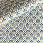hand block printed wrapping paper with a small flower design in indigo and green surrounded by a gold trellis design. By Paper Mirchi