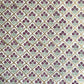 Hand block printed wrapping paper with a trellis pattern with flowers in cherry red, green and gold.