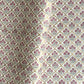 hand block printed wrapping paper by Paper Mirchi.  Repeat pattern of little flowers in pink and green within a gold trellis design.