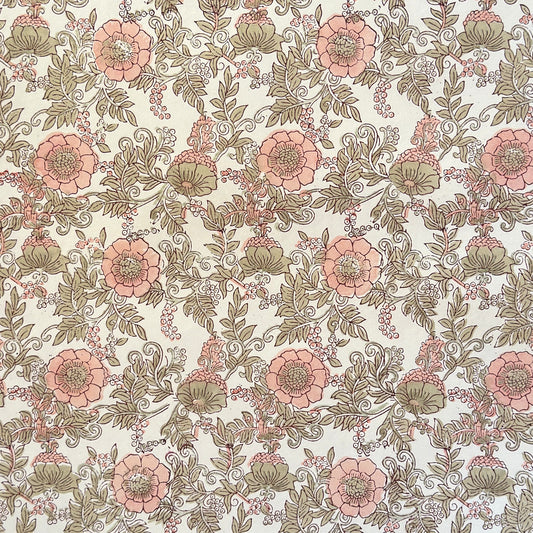 a hand block printed sheet of wrapping paper with a wild rose design in coral, moss green on a white background