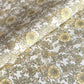 a sheet of hand block printed wrapping paper with a wild rose pattern in buttermilk yellow, moss green and gold