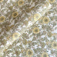 a sheet of hand block printed wrapping paper with a wild rose pattern in buttermilk yellow, moss green and gold