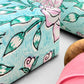 wrapping paper with repeat botanical rose pattern in light aqua and pink by Paper Mirchi