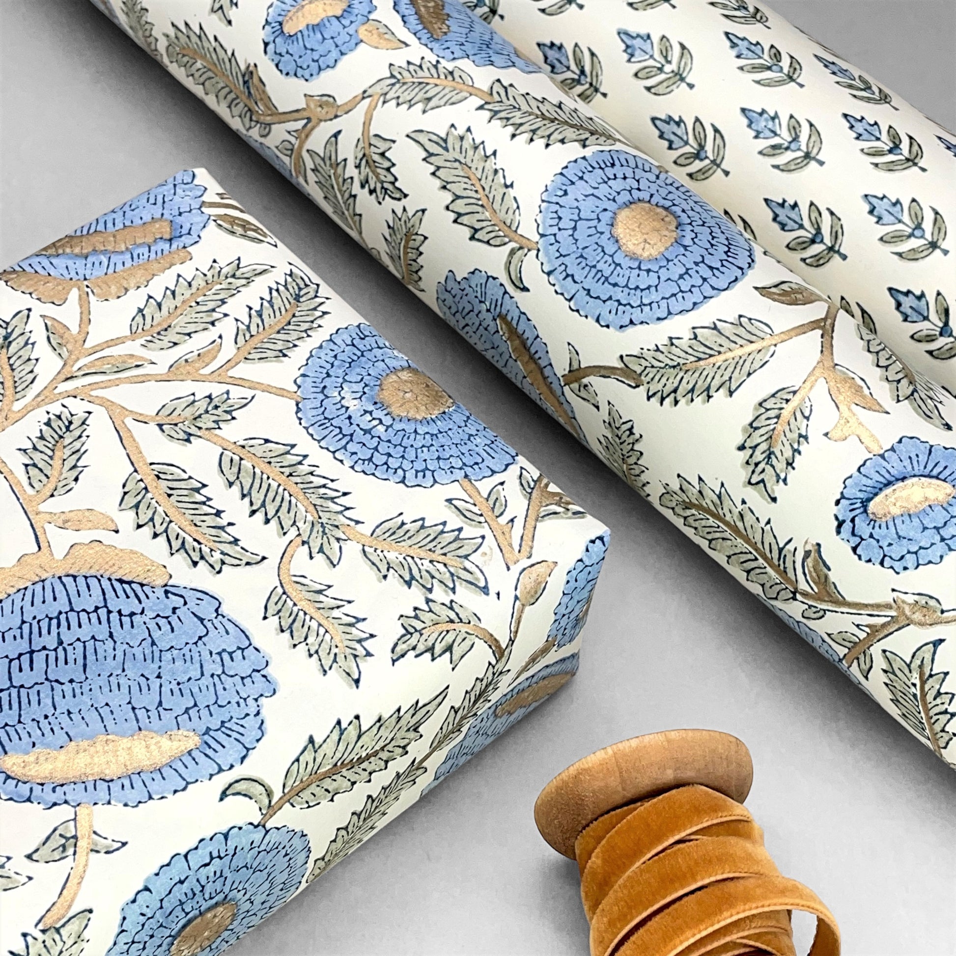 wrapping paper with repeat botanical pattern in blue, gold and green by Paper Mirchi