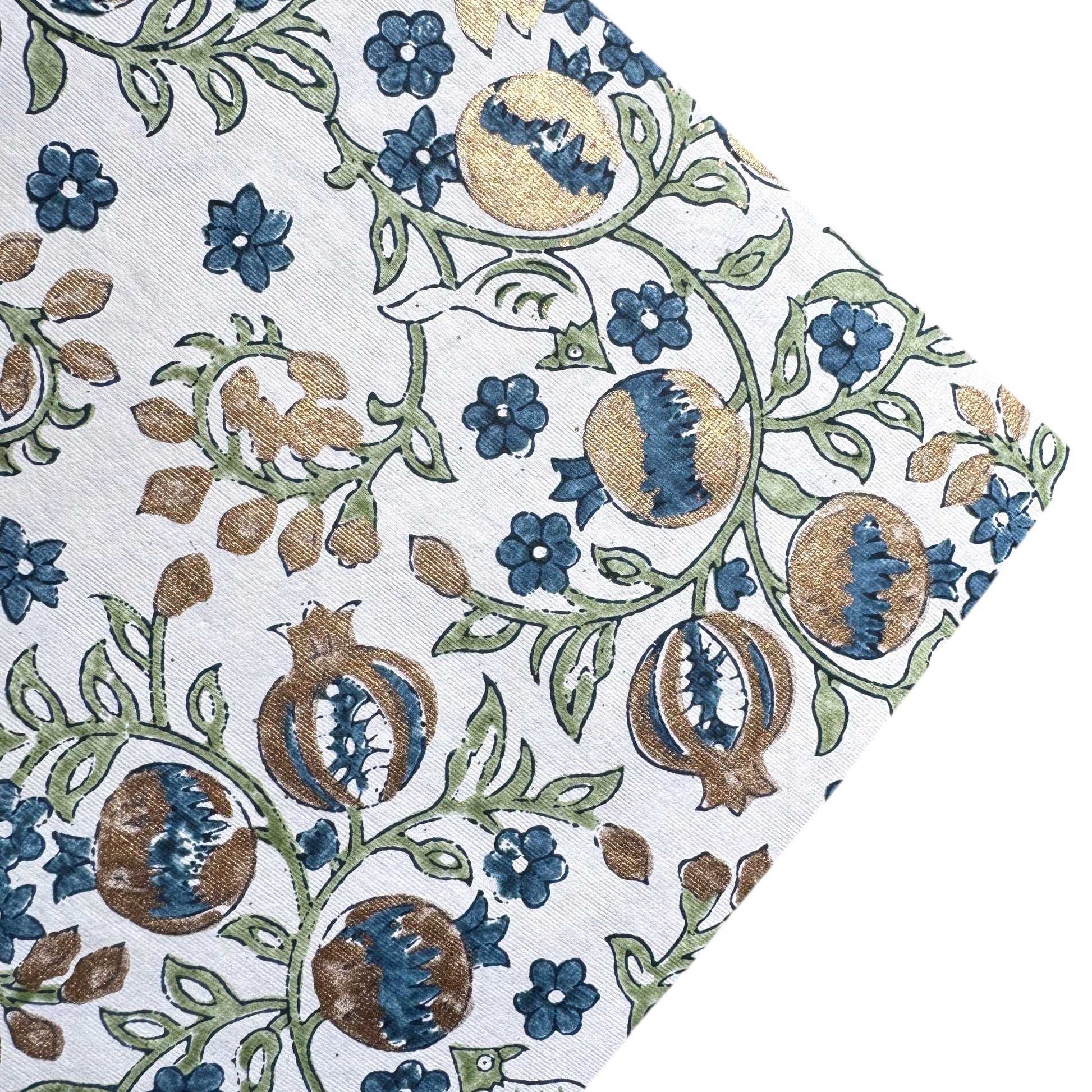 hand block printed wrapping paper with a pomegranate design in indigo and green with gold accent. By Paper Mirchi