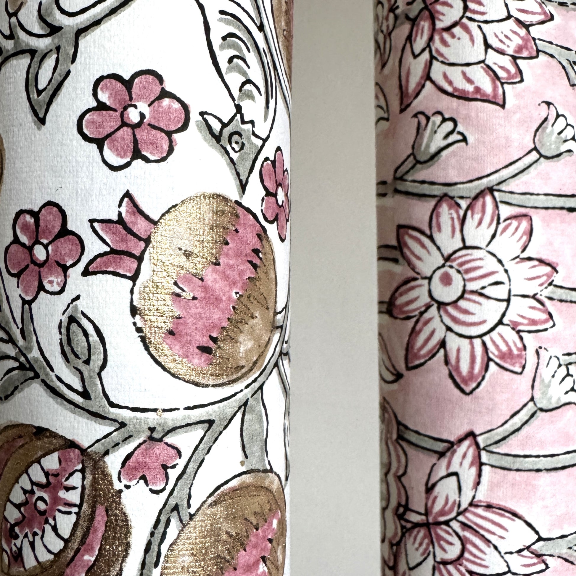 hand block printed wrapping paper by Paper Mirchi.  Repeat pattern of pomegranates in pink and green within a gold accent design. Close up of the pomegranate and a little bird