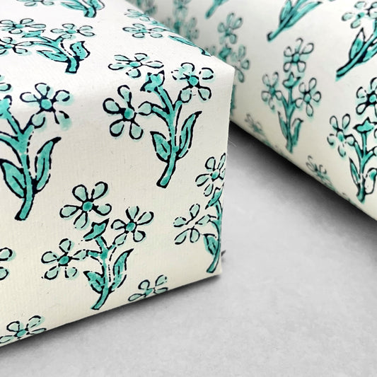 wrapping paper with repeat block print little floral pattern in aqua by Paper Mirchi