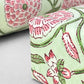wrapping paper with repeat botanical pattern in pistachio green and pink by Paper Mirchi