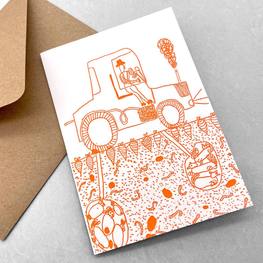 letterpress greetings card of a drawing of a tractor and what is living in the ground beneath, orange ink on white by Passenger Press