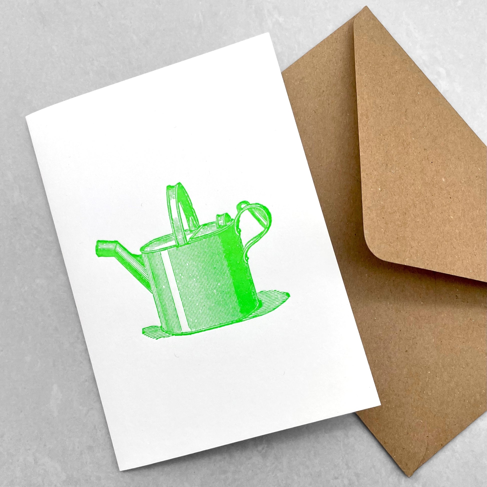 letterpress greetings card of a drawing of a watering can, lime green ink on white by Passenger Press