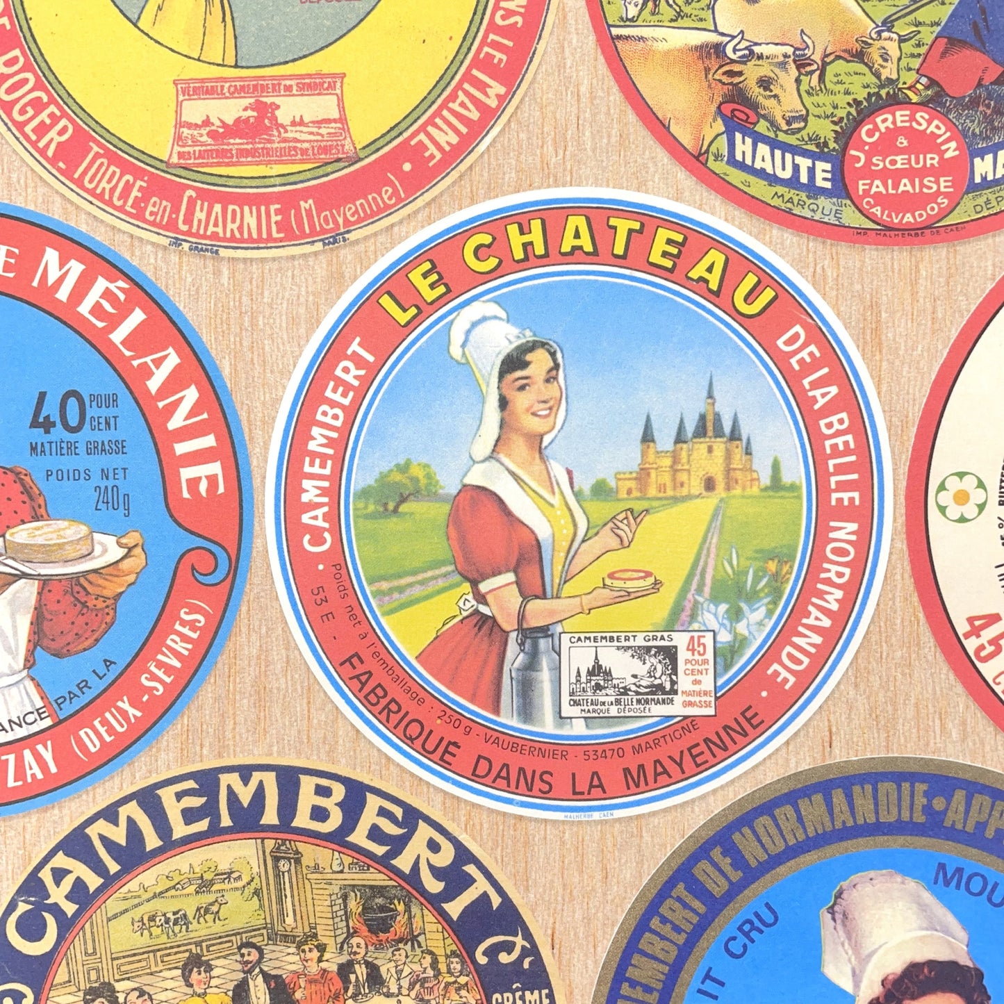 Poster wrap by The Pattern Book. this sheet of wrapping paper is covered with images of vintage camembert cheese wrappers. Detail image showing a couple of the labels