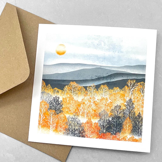 A greetings card by Ruth Thorp Studio of an autumnal landscape with trees in full autumn colour in the mist, with envelope