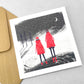 A pack of 4 cards with different designs inspired by snowfall, by Ruth Thorp Studio. Two children with red coats watching the snow
