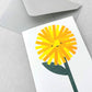 Mini greetings card with drawing of a dandelion with a smily face. By Scout Editions.