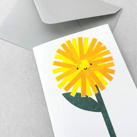Mini greetings card with drawing of a dandelion with a smily face. By Scout Editions.