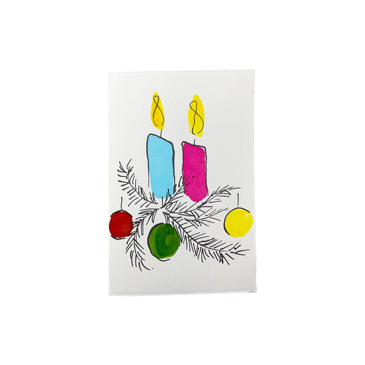 A letterpress printed card by Scribble & Daub. Two candles with foliage and baubles hand painted in a bright 70s colour palette of pink, red, yellow, light blue and green