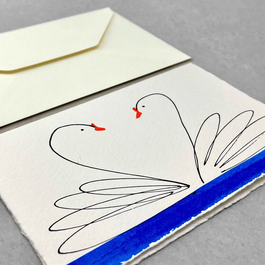 hand-painted greetings card of two swans facing each other, their heads make a heart shape, by Scribble and Daub