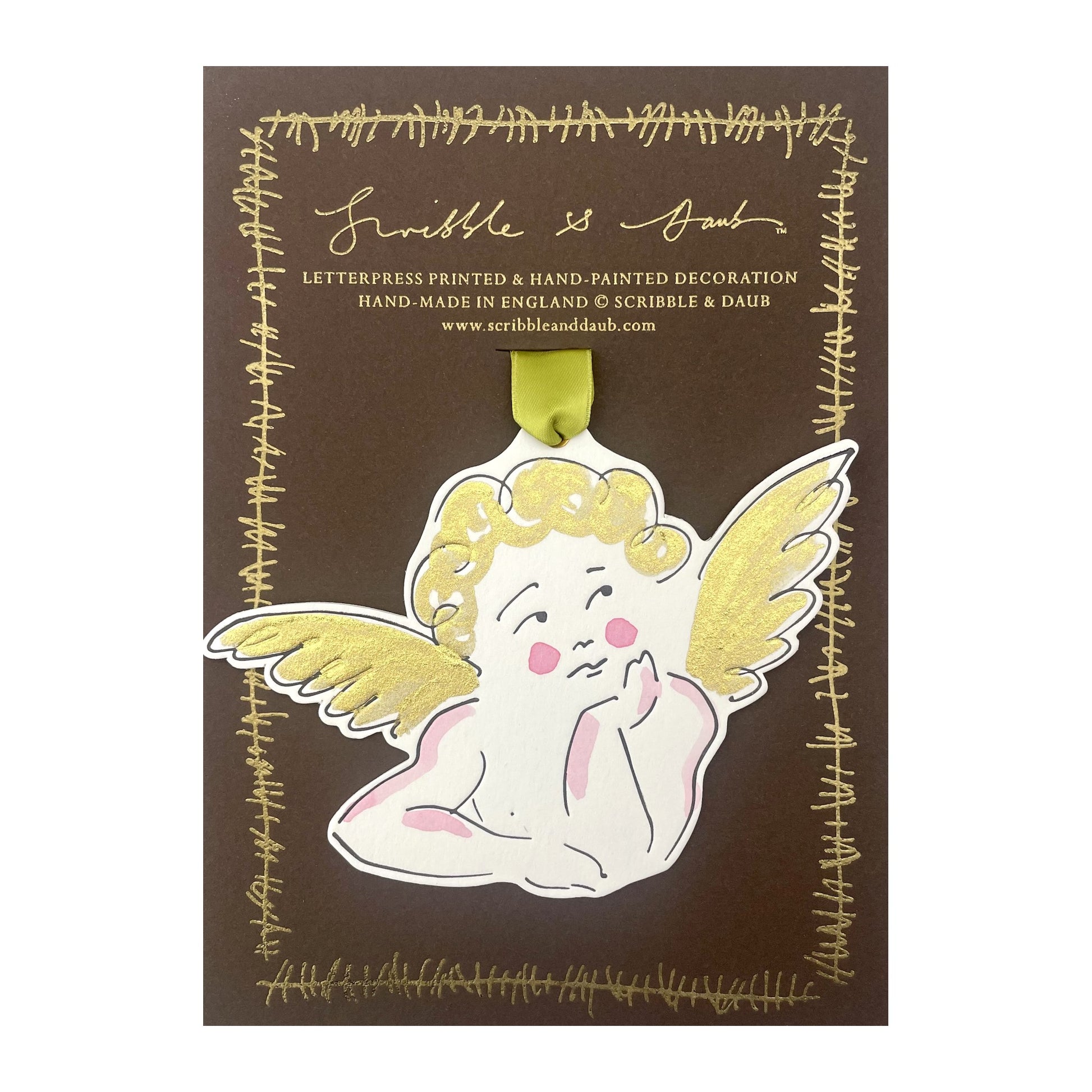 a cherub shaped hanging ornament made of thick 1050gsm off-white card, letterpress printed in black and then hand painted in pale pink and gold ink. It has a chartreuse green satin ribbon to hang the ornament with. By Scribble & Daub. Pictured on a gold-foiled brown board.