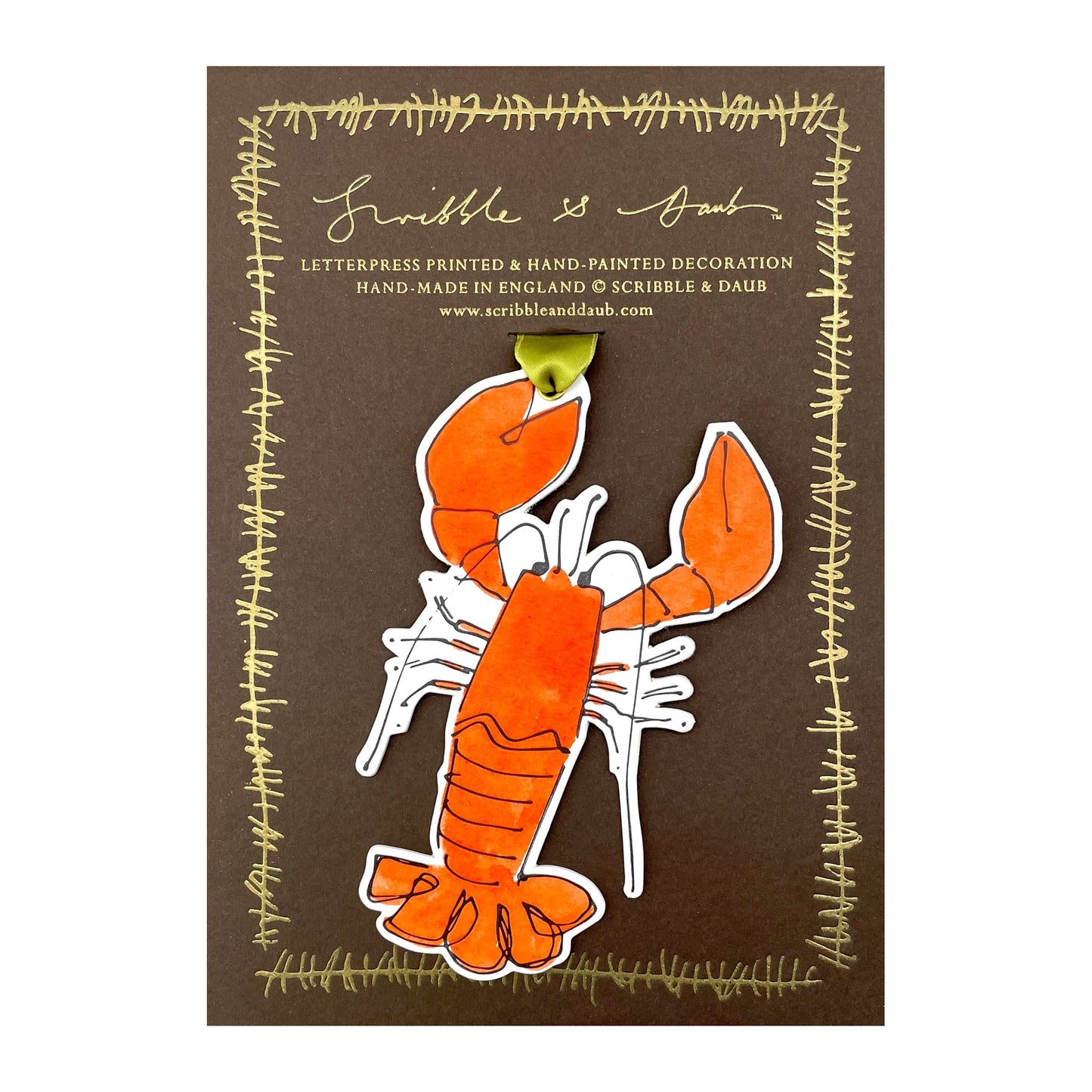 a lobster shaped hanging ornament made of thick 1050gsm off-white card, letterpress printed in black and then hand painted in orange ink. It has a chartreuse green satin ribbon to hang the ornament with. By Scribble & Daub. Pictured on a gold-foiled brown board.
