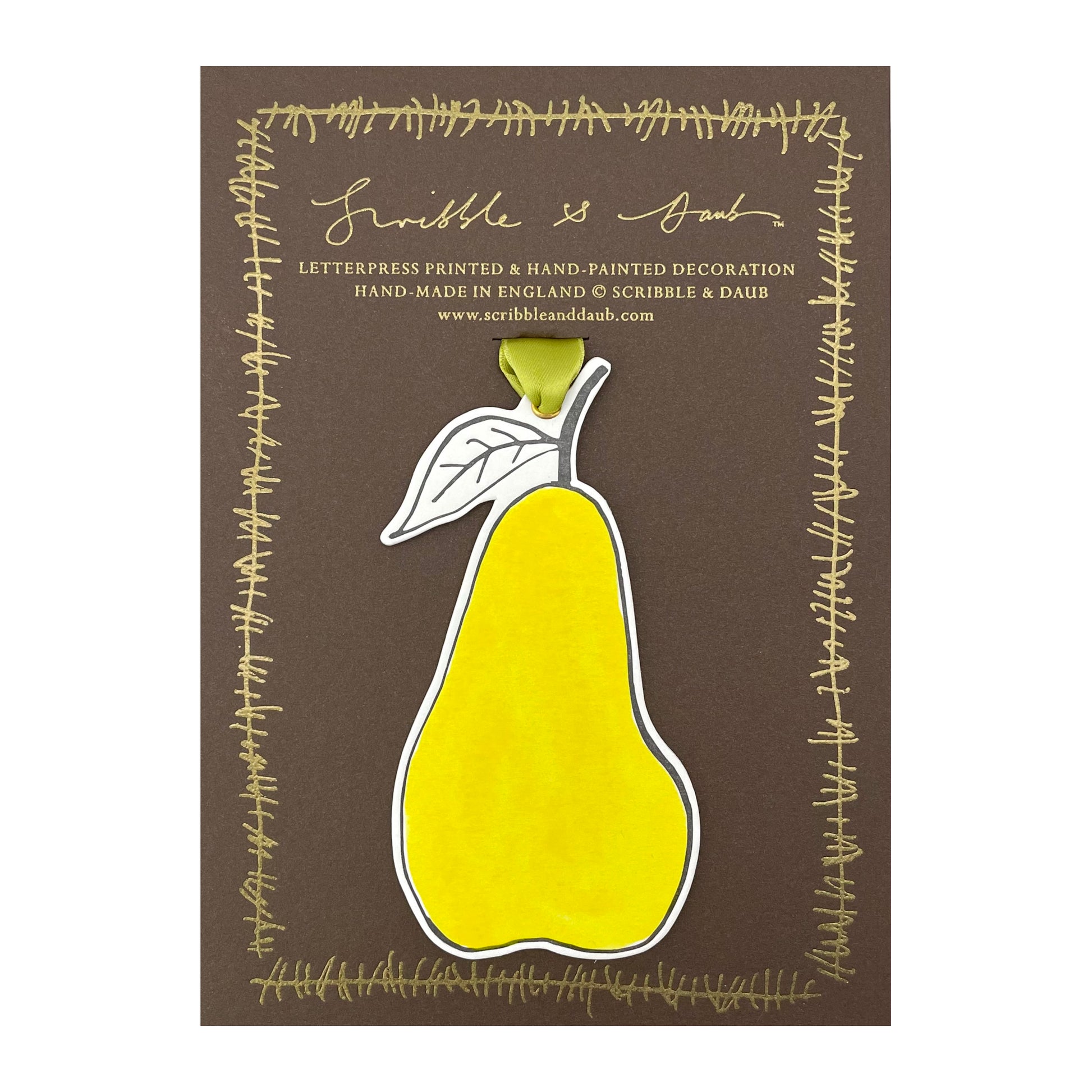 a pear shaped hanging ornament made of thick 1050gsm off-white card, letterpress printed in black and then hand painted in bright yellow ink. It has a chartreuse green satin ribbon to hang the ornament with. By Scribble & Daub. Presented on a gold-foiled brown board.