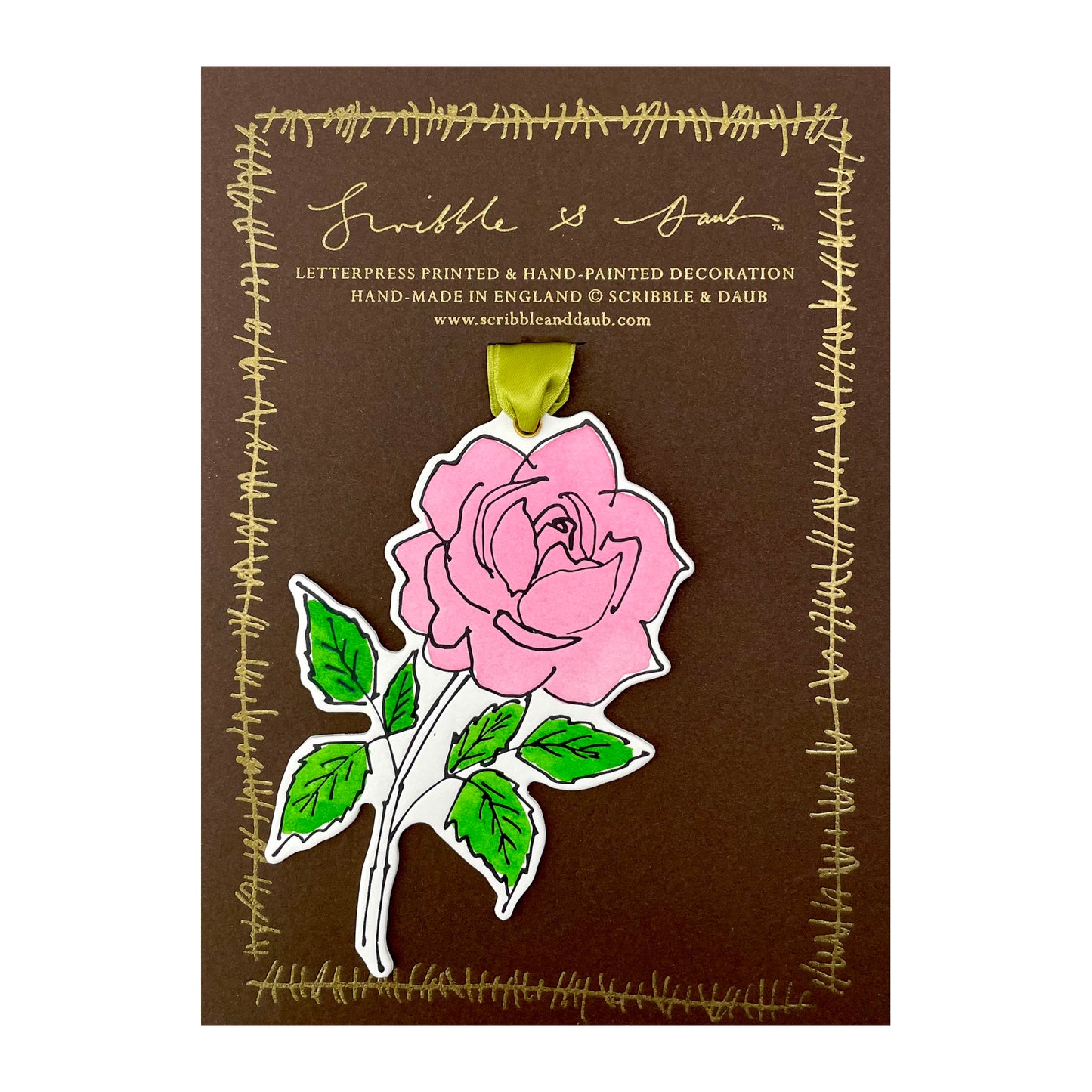 a rose shaped hanging ornament made of thick 1050gsm off-white card, letterpress printed in black and then hand painted in pink and green ink. It has a chartreuse green satin ribbon to hang the ornament with. By Scribble & Daub. Pictured on a gold-foiled brown board.