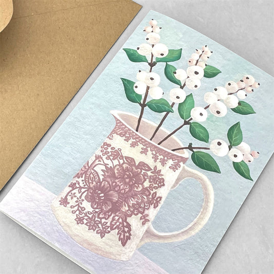 greeting card of a painting of white snowberries in a cream and pink patterned jug, pale grey background by Susie Hamilton