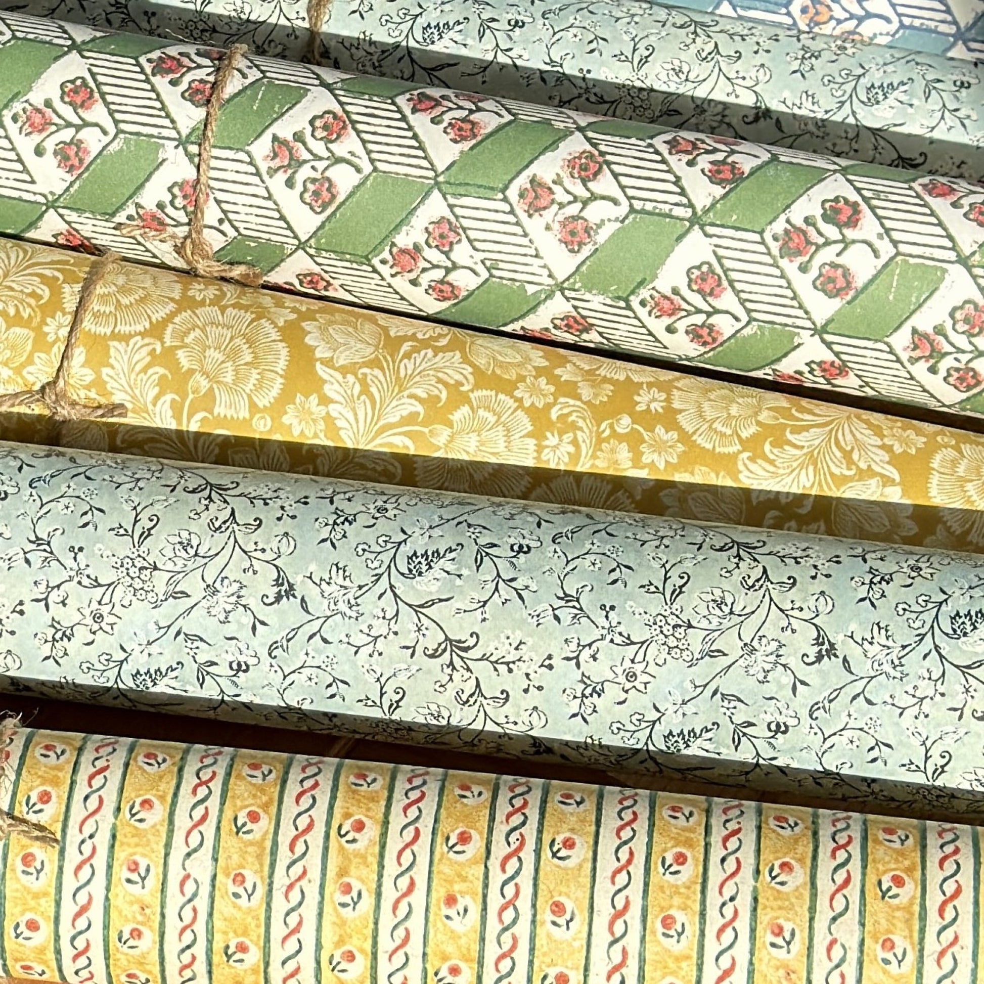rolls of florentine remondini wrapping papers with patterns in green, yellow and blue